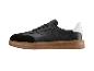 Baskets noires pour hommes avec semelle marron et détail blanc au talon.