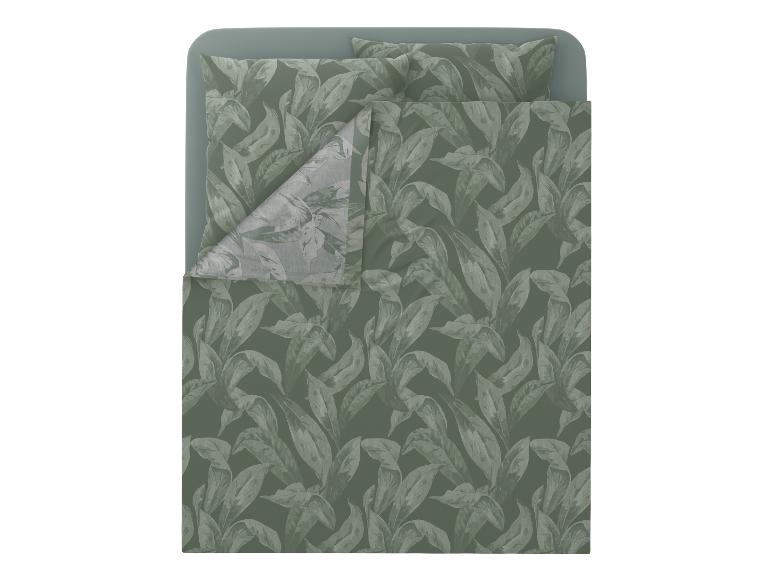Parure de lit à motif feuilles vertes sur un lit.