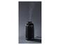 Diffuseur d'arômes noir cannelé, émettant de la vapeur.