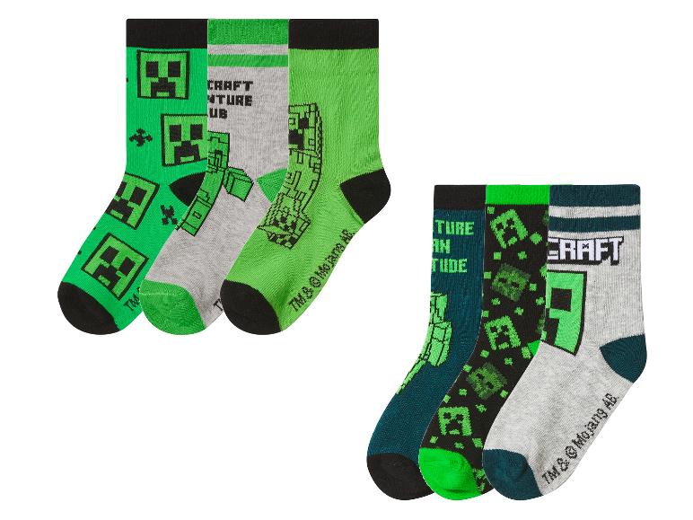 Six paires de chaussettes pour enfants avec des motifs de jeux vidéo, dans des tons verts, gris et noirs.