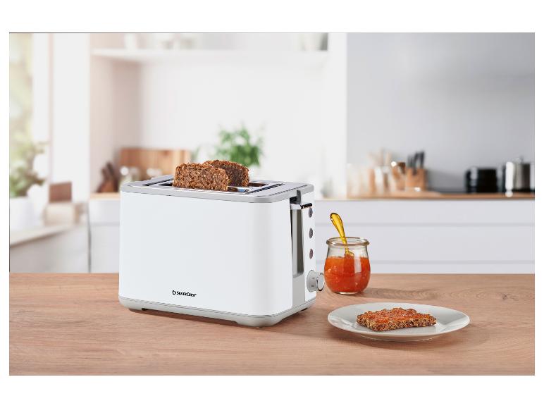 Grille-pain SilverCrest avec pain et confiture sur un comptoir de cuisine.