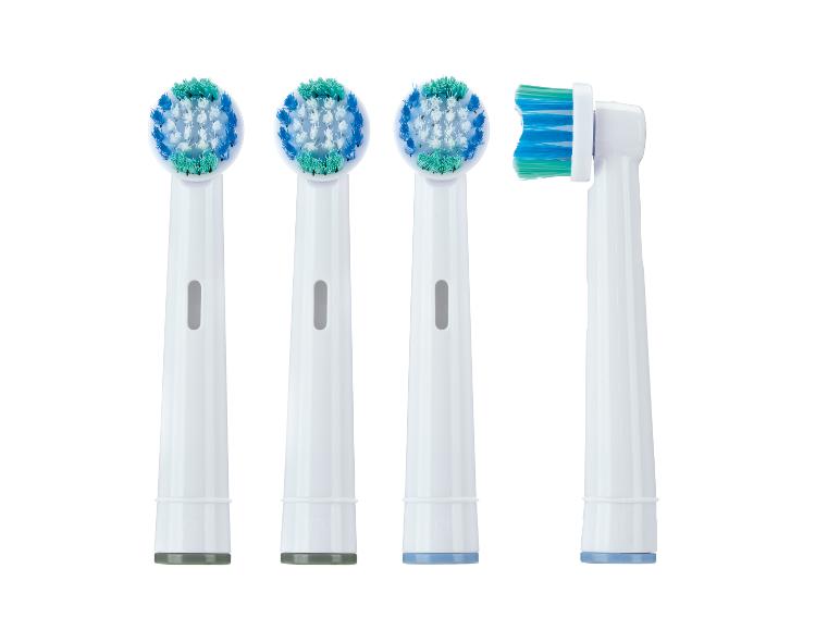 Quatre têtes de brosse de rechange pour brosse à dents électrique, trois rondes et une rectangulaire.