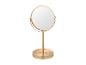 Miroir de table doré avec cadre rond.