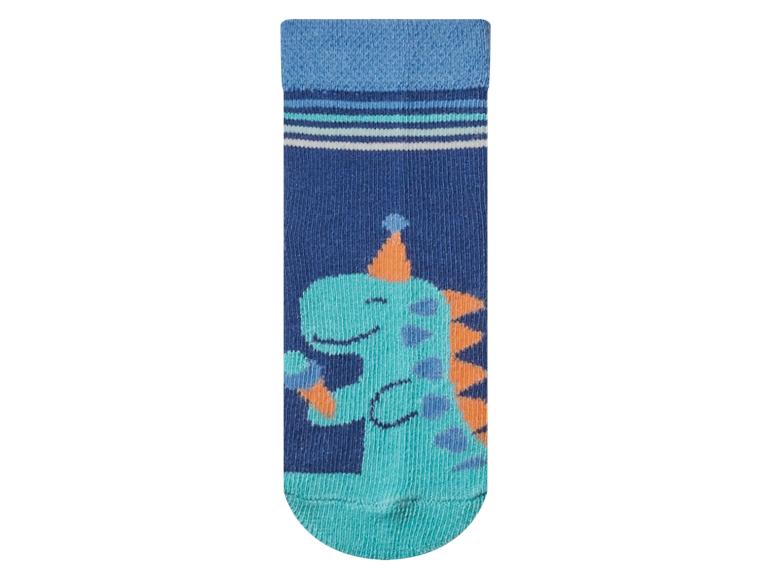 Chaussette enfant bleue avec un motif de dinosaure de fête