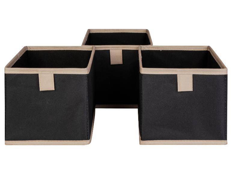 Trois boîtes de rangement noires avec des bords beiges.