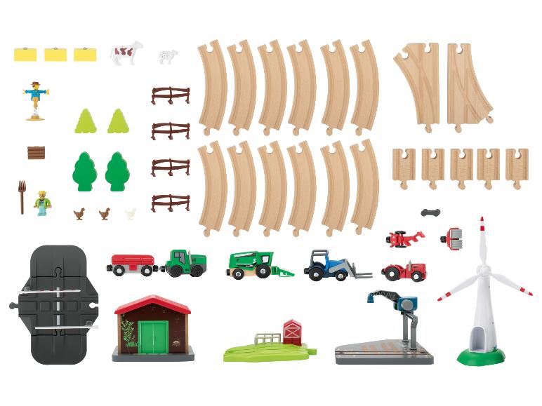 Ensemble de train jouet sur le thème de la ferme, avec rails, véhicules et accessoires.