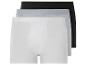 Trois paires de boxers en blanc, gris et noir.