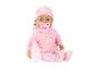 Poupée bébé en tenue rose à cœurs, avec sucette et biberon.