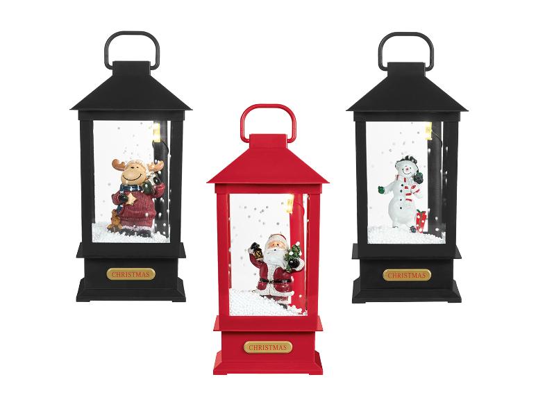 Lanternes de Noël avec des figurines de renne, de bonhomme de neige et de Père Noël.