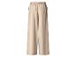 Pantalon large beige avec taille élastique et poches latérales.