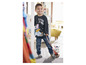 Un garçon porte un t-shirt Peppa Pig et un jean bleu et tient un cheval en peluche.