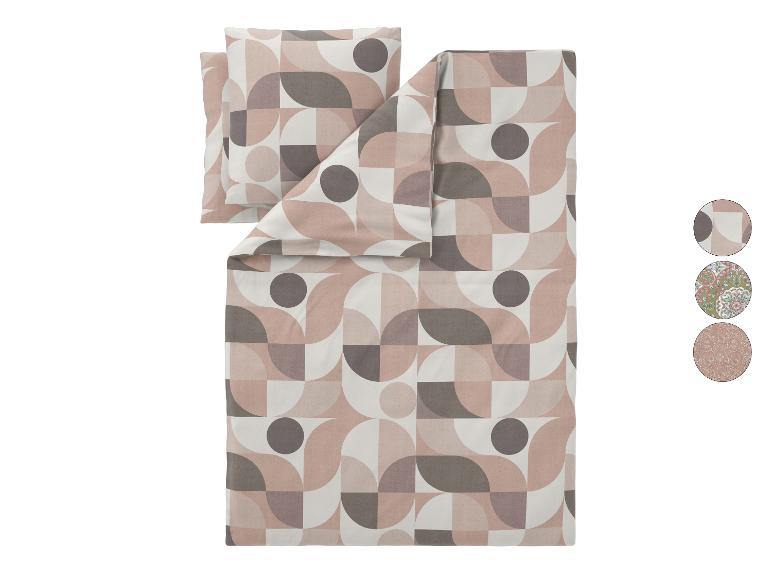 Parure de lit avec oreiller, motif géométrique dans les tons rose et gris.