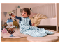 Bébé dans une gigoteuse avec un jouet.