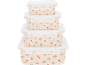 Pile de boîtes alimentaires avec motif festif de cannes à sucre et de houx.