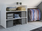 Une armoire avec des vêtements, des chaussures et des boîtes de rangement.