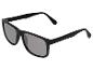 Lunettes de soleil noires avec verres gris, vue en angle.