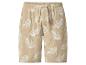 Shorts en mousseline beige avec imprimé feuilles blanches et cordon.