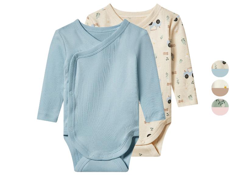 Deux bodys bébé, un bleu et un beige à motif ferme, avec boutons-pression.
