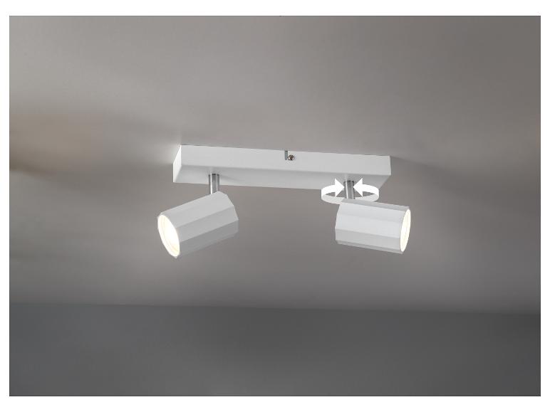 Lampe de plafond blanche à deux spots orientables.