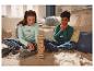 Deux enfants en pyjama à carreaux jouent à un jeu de blocs en bois.