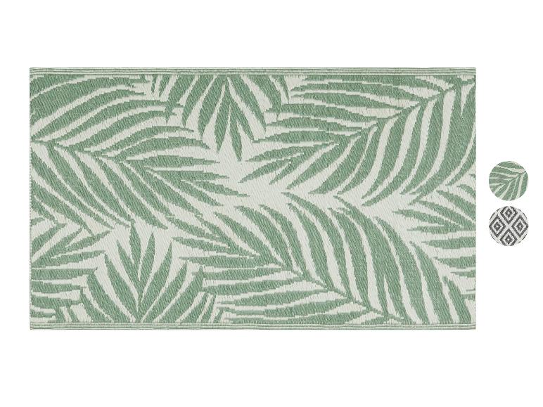 Tapis d'extérieur avec motif de feuilles de palmier en vert et blanc.