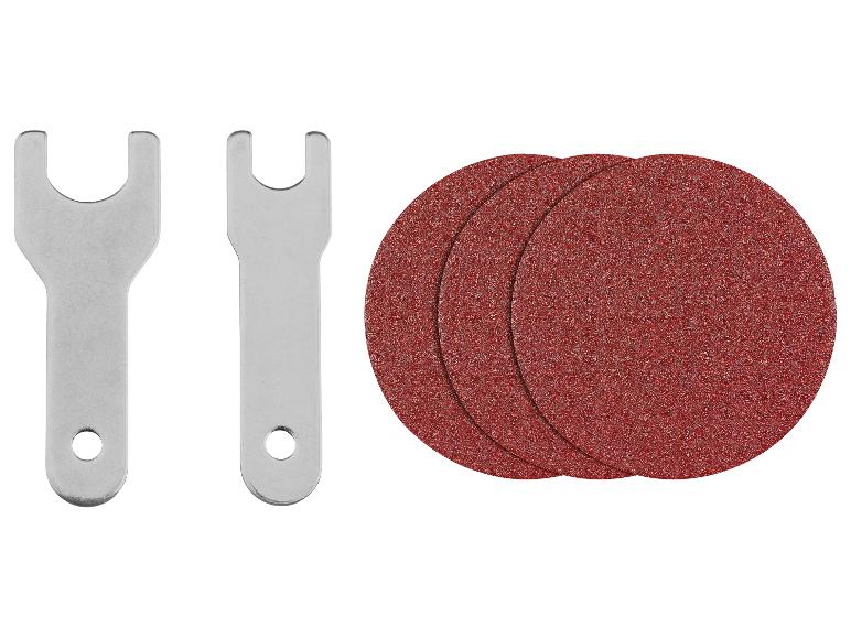 Deux clés métalliques et trois disques abrasifs rouges.