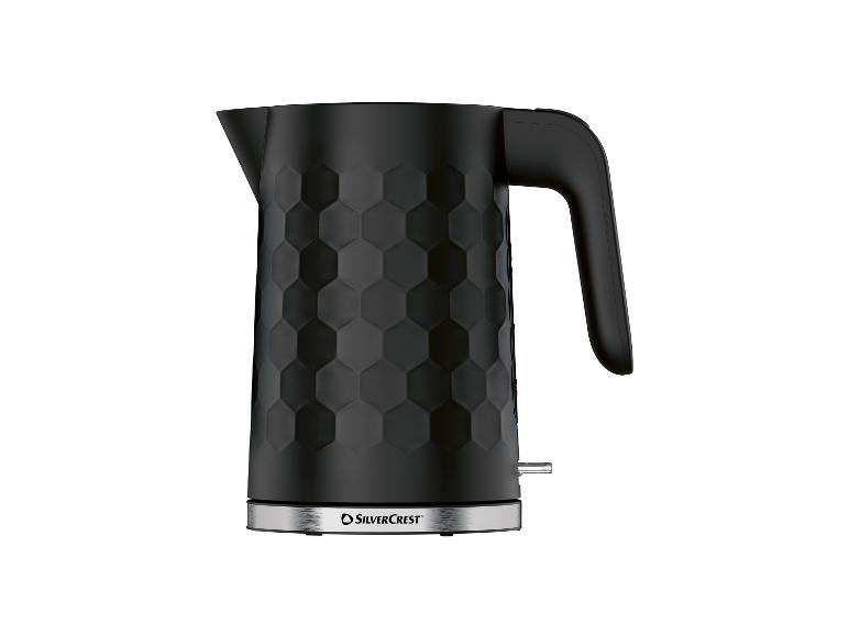 Bouilloire électrique noire avec motif hexagonal et base en acier inoxydable.