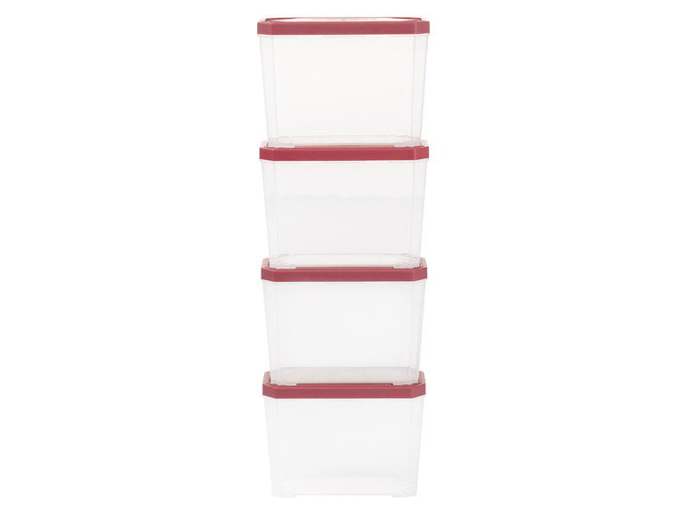 Quatre boîtes de rangement transparentes avec des couvercles rouges.