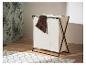 Un panier à linge pliable à trois compartiments, en tissu beige et structure noire, posé sur un sol en bois.