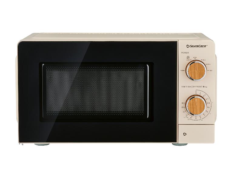 Micro-ondes beige avec panneau noir et deux cadrans en bois pour la puissance et le temps.