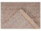 Tapis beige avec dessous antidérapant visible
