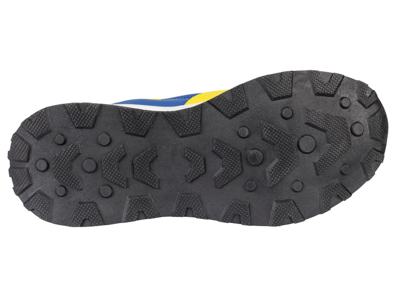Semelle noire d'une basket bleue et jaune.