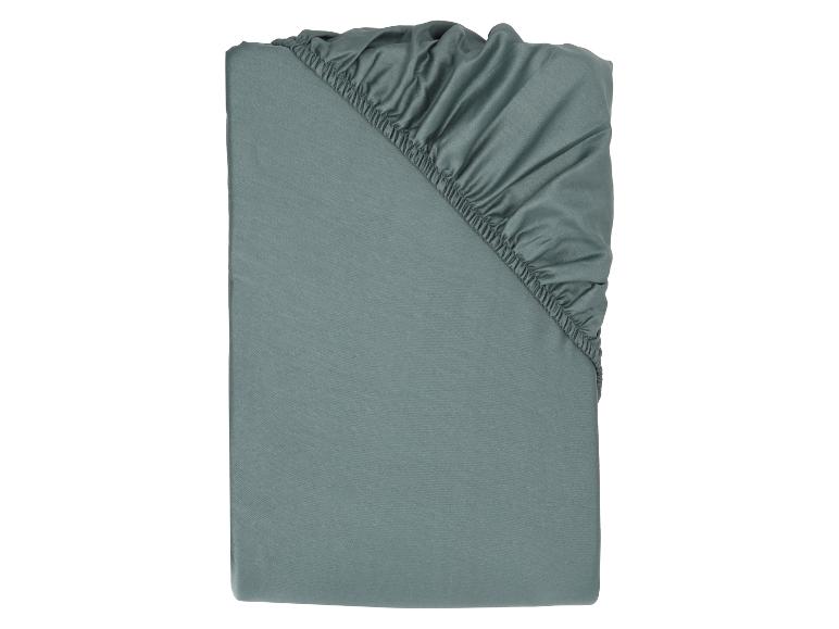 Drap-housse gris-vert plié avec élastique visible
