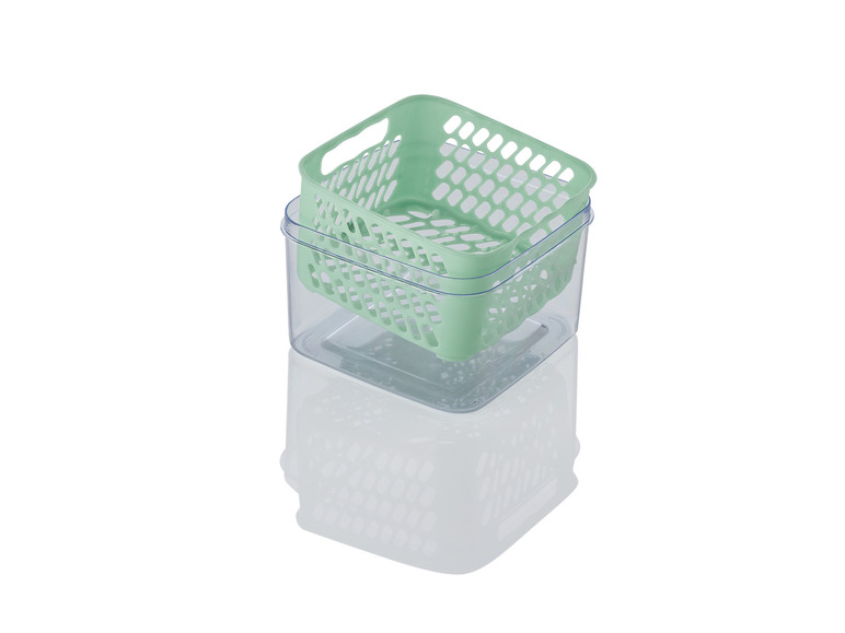 Un panier en plastique vert sur une boîte de rangement transparente.