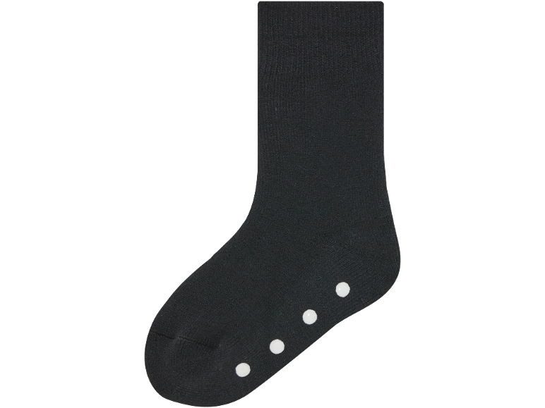 Chaussettes antidérapantes noires avec des points blancs sur la semelle.