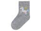 Une chaussette grise avec une licorne arc-en-ciel dessus