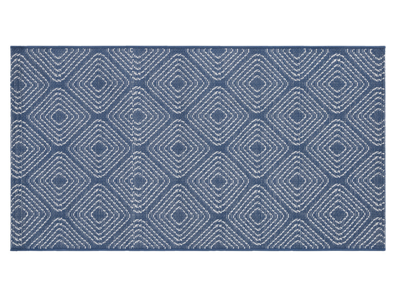 Un tapis bleu avec un motif géométrique blanc.