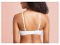Une femme portant un soutien-gorge blanc en tissu lisse.