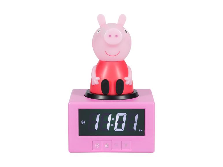 Réveil numérique rose avec un personnage de cochon dessus, affichant 11:01 PM.