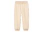 Pantalon de survêtement crème avec une ceinture élastique.
