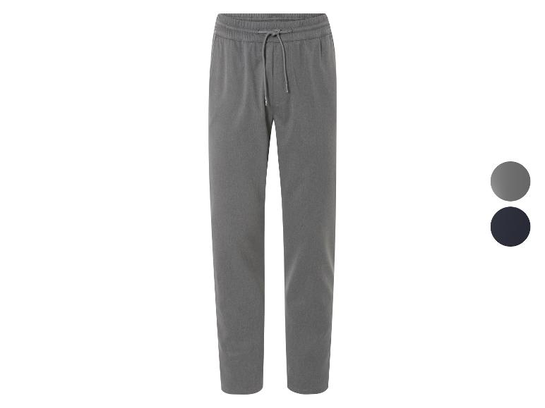 Pantalon de survêtement gris avec élastique et cordon de serrage.