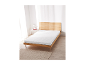 Matelas en mousse confort LIVARNO HOME Easy sur un lit en bois dans une chambre lumineuse.