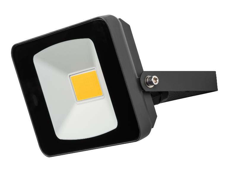 Projecteur LED noir avec source de lumière jaune, monté sur fond blanc.