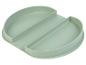 Une assiette bébé en silicone verte avec deux compartiments.