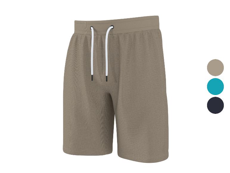 Shorts de survêtement beige avec cordon de serrage blanc, avec options de couleur bleue et noire.