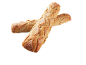 Deux baguettes de pain croustillantes avec de la farine, croisées sur fond noir.