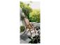 Une chaise de jardin en bois sur un balcon avec vue sur les arbres.