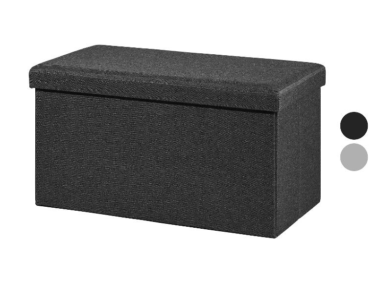 Un pouf de rangement en tissu gris foncé avec un dessus rembourré.