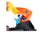 Un ensemble de jeu Hot Wheels avec un dragon orange attrapant une voiture bleue.