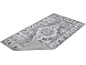 Tapis gris avec motif floral et médaillon central, avec le dos antidérapant visible.